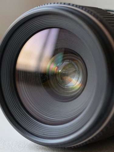 Macro close-up of a high-tech smartphone camera lens reflecting soft window light, showing dust particles and realistic glass texture, 50mm lens