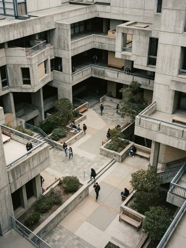 High-angle architectural geometry of a quiet concrete library courtyard, soft overcast daylight, desaturated cool tones with warm cream undertones, 35mm film grain