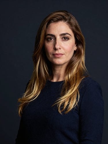 Professional portrait of founder Amina Driouech in a clean, academic setting, dark navy background, gold highlights, sharp focus