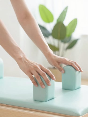 Close-up of hands gently guiding a movement on a wooden Pilates reformer, soft-focus background with green plants and bright natural daylight.