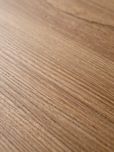 Extreme macro close-up of quarter-sawn oak grain, cool studio strobe light raking across the surface to reveal medullary rays and fine figure, full-height portrait framing, no warm filtering, grain fills the frame edge to edge