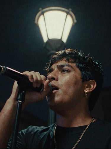 Extreme close-up anamorphic shot of a young Mexican musical artist singing under a neon-lit streetlamp in CDMX, moody shadows, 35mm film grain.