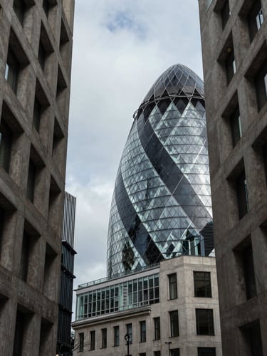 High-end, quiet London financial district architecture, concrete and steel structures, cool overcast daylight, sharp geometric shadows.