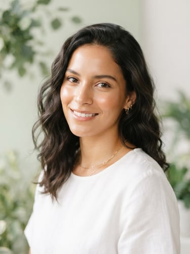 Elegant portrait of a Colombian woman with radiant skin, soft natural daylight, minimalist botanical background with sage green tones, bright clean studio lighting