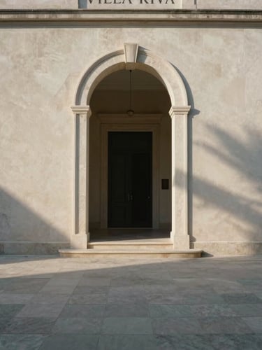 A wide-angle, one-point perspective architectural shot of the travertine entrance of Villa Riva, soft morning light casting long shadows, minimalist plaster walls.