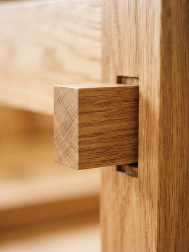 Macro detail shot of a perfectly aligned mortise and tenon joint in warm Oregon white oak, soft diffused Pacific Northwest window light, shallow depth of field, 35mm.