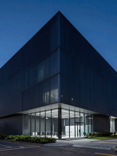 Sleek architectural wide angle of a modern minimalist corporate office in São Paulo, cool-toned studio lighting with deep navy and electric blue accents, sharp focus