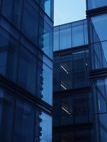 Sleek corporate technology architecture, abstract geometric glass structures reflecting cool blue light, high contrast studio lighting, minimalist composition