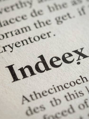 Macro photograph of a printed scientific index, crisp black serif typography on textured cream paper, shallow depth of field, cool daylight.