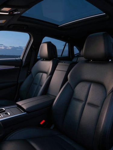 Close-up interior shot of a clean, luxurious black sedan, showing leather seats and subtle ambient lighting, captured with a wide-angle lens at blue hour, sharp details.