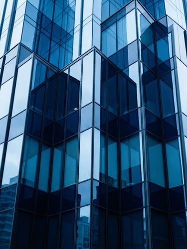 A crisp corporate architectural glass facade reflecting cool daylight, sharp angles, deep navy and electric blue tones, 35mm