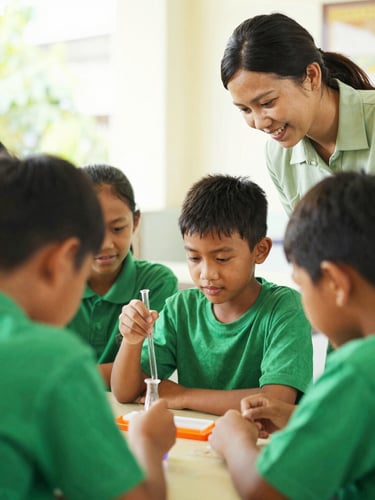 Candid medium shot of Indonesian elementary students collaborating on a science project with a teacher, smiling, warm natural light, soft green tones.