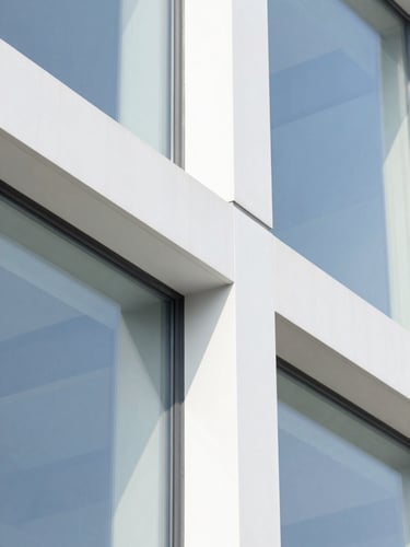 Close-up macro of a modern glass-and-steel architectural detail, high-key bright daylight, crisp white and cobalt accents, abstract corporate minimalism