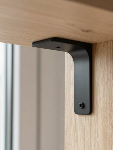 Close-up detail shot of a matte black steel bracket connecting two light ash wood panels, showing a scratch-resistant laminate finish, natural afternoon window light, sharp focus, 35mm