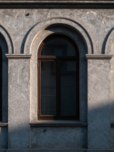 Wide architectural detail of a Balkan city at early morning — concrete facade with deep-set arched window, cool north-facing light, high contrast shadows, no people, geometric composition