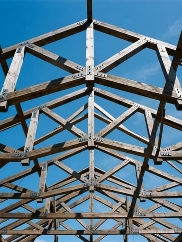 Low-angle architectural shot of complex exposed timber roof trusses under a crisp blue sky, sharp shadows highlighting structural depth, 35mm