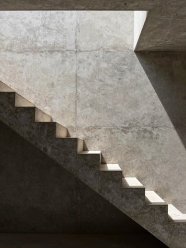 Extreme close-up of a travertine staircase floating against a raw concrete wall, precise shadow line cast by a narrow skylight above, no people, no decor, architectural geometry only
