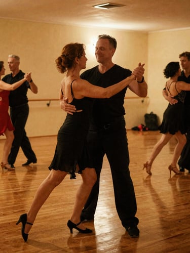 A young ballet student practicing posture with a female dance instructor in a studio.