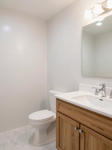 Wide-angle architectural photograph of a bright, completed bathroom remodel, clean grout lines, custom oak vanity, natural light, 35mm lens.