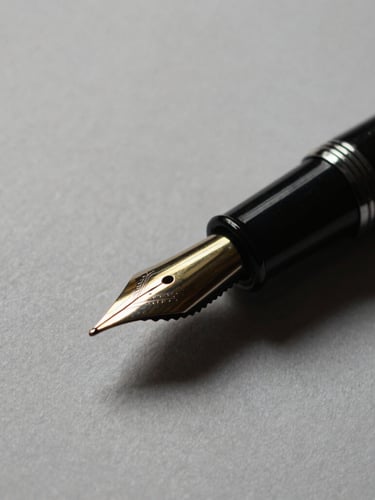 Macro close-up of a premium black fountain pen resting on heavy textured paper, sharp directional light, deep gold ink reflection, minimalist
