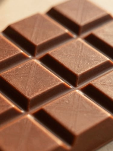 Close-up of a textured chocolate bar wrapper in warm terracotta tones, natural golden-hour lighting, shallow depth of field, 35mm