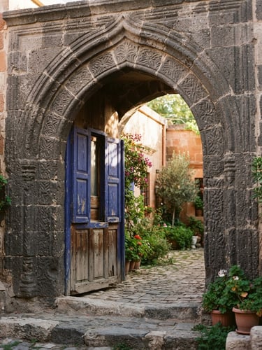 Warm editorial photo of a historic stone mansion archway in Gaziantep, soft morning sun filtering through, showing hand-carved basalt textures and a glimpse of a blue shutter, 35mm.