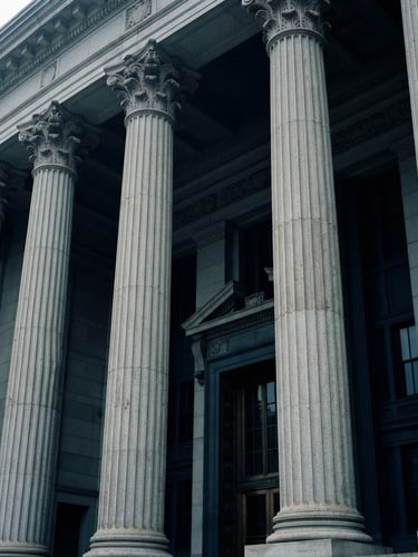 Architectural close-up of a New York City courthouse facade, sharp limestone columns, cool overcast daylight, desaturated navy tones, 35mm lens.