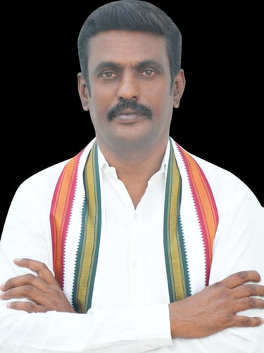A portrait of an Indian politician with a mustache, wearing a white shirt and a traditional tricolor stole.