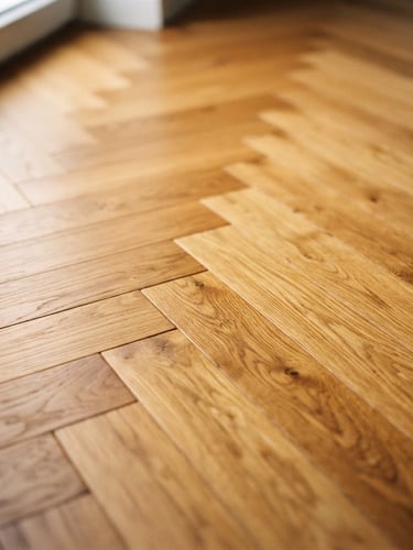 Close-up of a beautifully restored herringbone parquet floor, warm oak tones, natural side-light from a window, shallow depth of field, 35mm