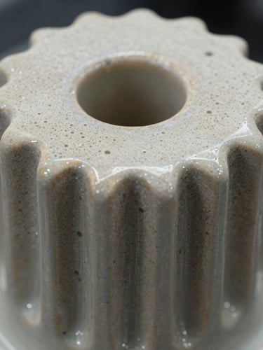 Extreme close-up of a ceramic PTC heating element showing the micro-crystalline surface structure, high-precision laboratory lighting