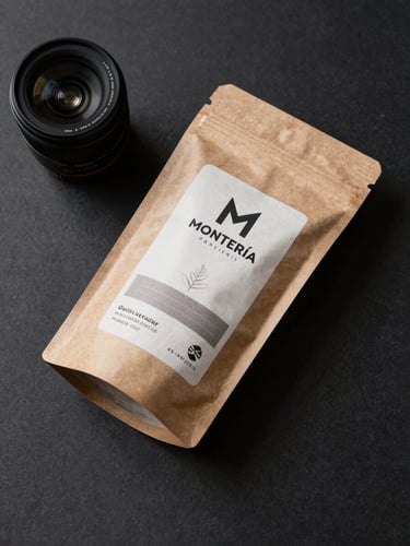 Studio overhead shot of a product and brand packaging on a matte dark surface, studio strobe reflected daylight, clean shadows, intentional commercial composition for a local Montería brand