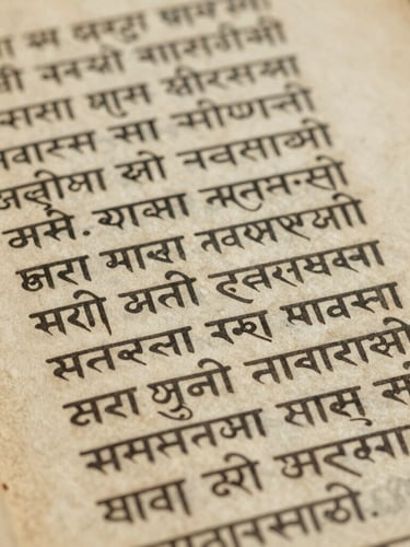 Close-up of an ancient Sanskrit palm-leaf manuscript, detailed texture of aged parchment, soft diffused library light, archival editorial photography, 35mm