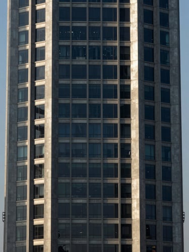 Symmetrical architectural shot of a modern financial tower in Panama City, sharp morning shadows, steel and concrete