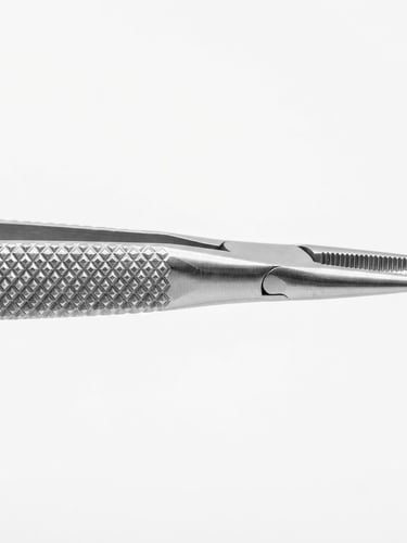 High-key macro photography of a surgical forceps tip, crisp studio light, seamless clinical white backdrop, sharp focus on knurled grip