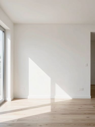 Straight-on architectural photograph of a pristine, newly renovated modern apartment living room, bright daylight, clean paint edges.