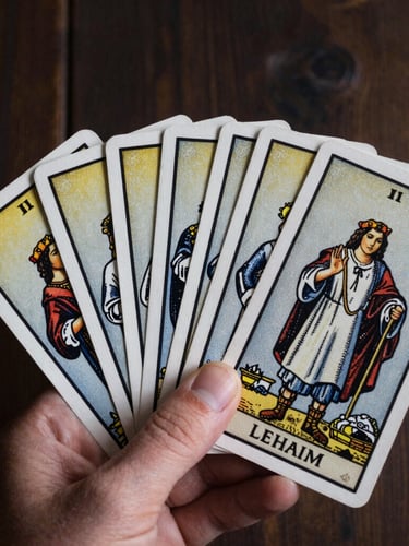 Close-up of Lehaim tarot cards held in hand, dramatic low-key natural light, dark wood background, 35mm photography