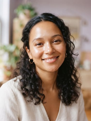 Portrait of a natural, diverse model with glowing, dewy skin, soft morning light, gentle champagne gold highlights, subtle lavender shadows, 35mm, relaxed candid portrait.