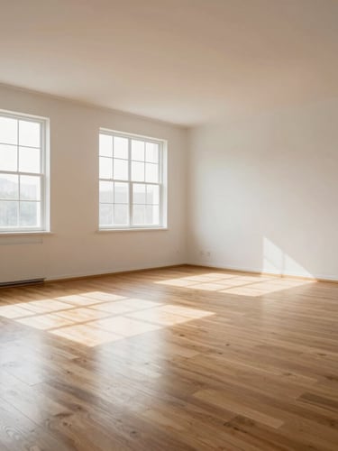 Wide environmental shot of a clean, light-filled empty room post-recovery, natural daylight streaming through large windows onto polished wood floors, professional and pristine.