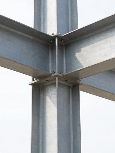 Close-up macro shot of heavy-duty structural steel column connection, bolted gusset plate, industrial architectural details, sharp focus