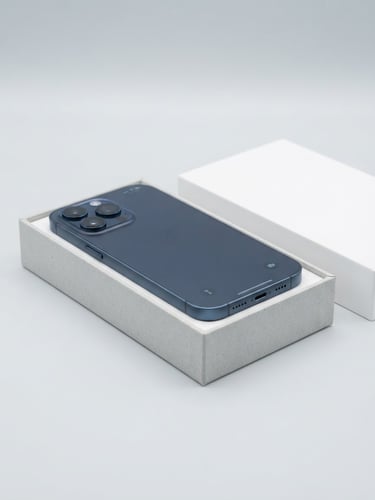 Crisp studio shot of a premium smartphone unboxed on a clean light gray background, high-key lighting, sharp focus