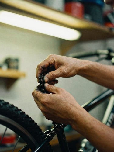 Close-up of grease-stained hands adjusting a bicycle chain, warm fluorescent workshop lighting, high contrast vibrant tones, 35mm film grain
