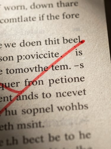 Extreme macro close-up of a screenplay page margin, heavy cream paper texture, dramatic red ink annotations crossing out dialogue, low-key chiaroscuro lighting, deep shadows.