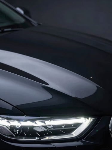 Extreme close-up of a luxury car's hood under harsh LED inspection lights, showcasing a razor-sharp, swirl-free mirror reflection on deep black paint, macro detail.