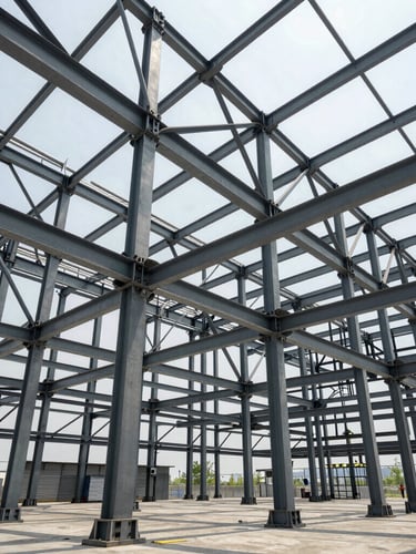 Wide-angle architectural view of massive structural steel framework under bright daylight, clean lines, industrial scale
