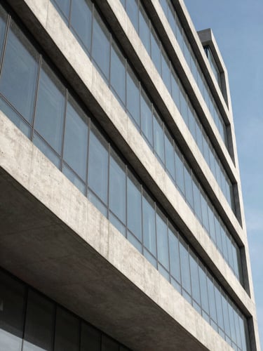 Abstract geometric architectural lines of a modern concrete and glass corporate building, sharp clean angles, high contrast daylight, conveying structure and institutional trust.