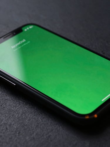 Extreme close-up macro shot of a physical Android phone screen showing a fluid, zero-jank UI transition with vibrant green accents. Moody, low-key studio lighting with sharp, colored rim lights reflecting off the glass screen, dark slate background.