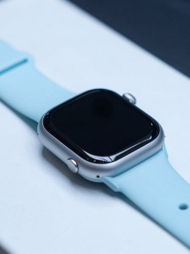 A modern smart watch on a high-precision testing bench, cool-toned cyan backlighting, sharp product photography