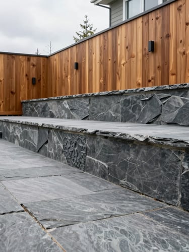 Sharp architectural photograph of a modern tiered backyard in Vancouver with slate gray paving stones and a structural retaining wall, overcast daylight, 35mm lens