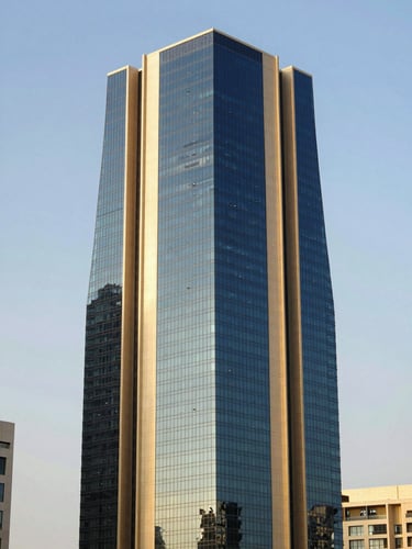 Modern architectural skyscraper in King Abdullah Financial District Riyadh, sharp focus, deep navy glass facade reflecting bright daylight, editorial style