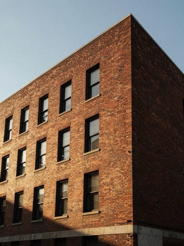 Low-contrast overcast architectural shot of a brick building facade in Buffalo, sharp clean geometric lines, 24mm wide-angle
